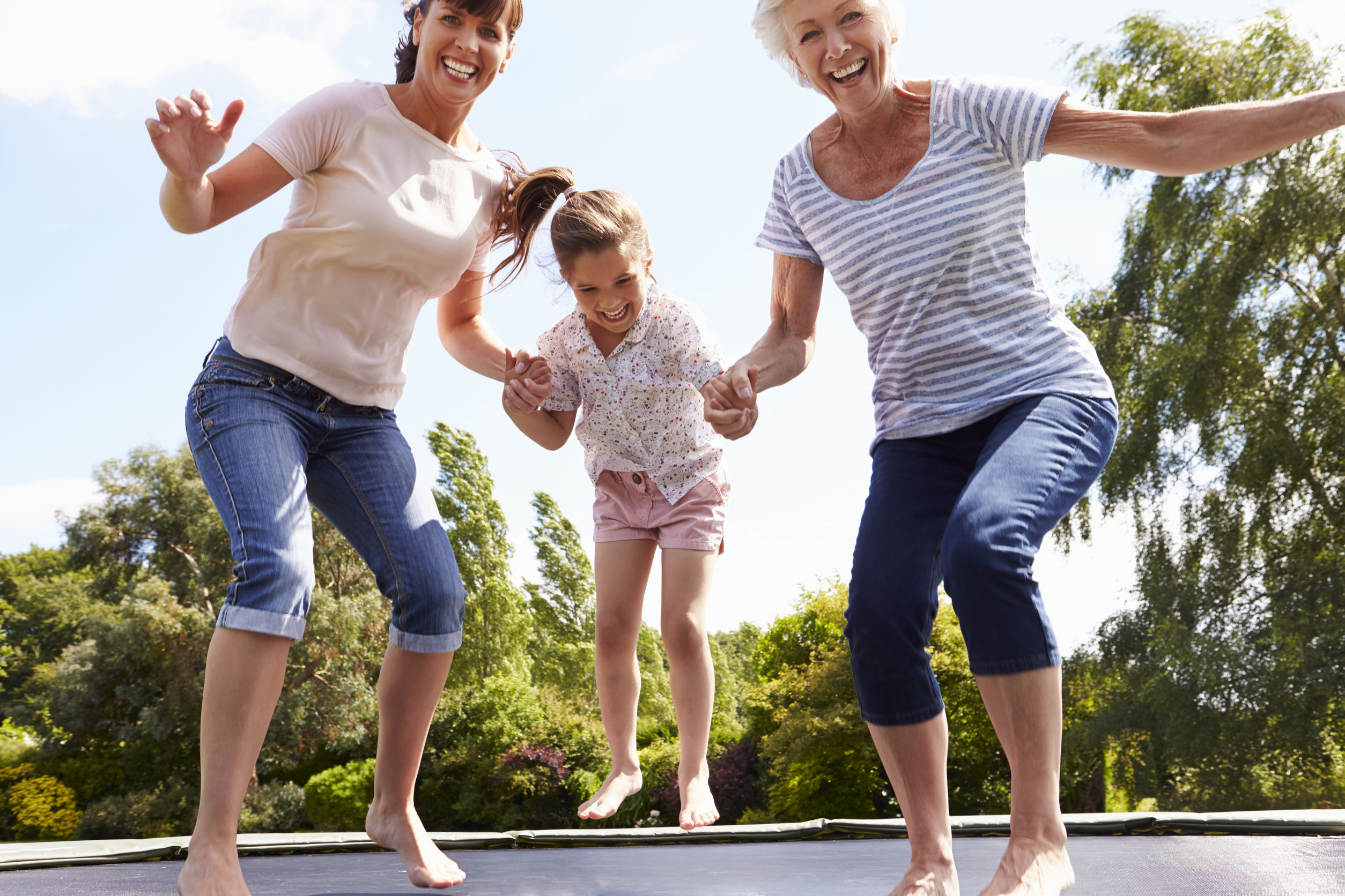 family jumping on trampoline