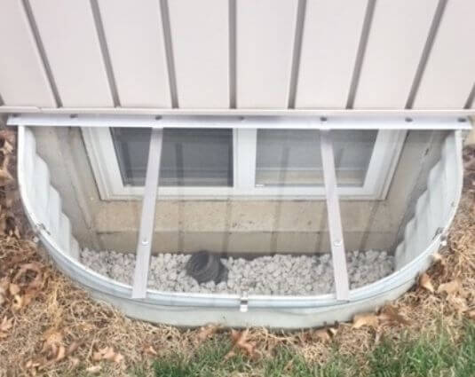 flat cover on a white metal window well