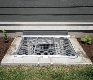 Mill-finish aluminum grate on concrete well