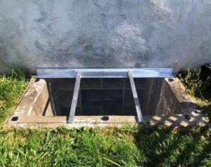 Sloped rectangular window well cover. Custom made by Window Well Experts.