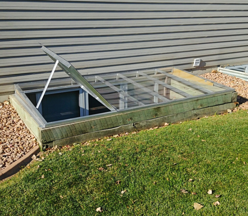 120 x 26 Super-slant cover with egress escape hatch. The hatch is propped open.