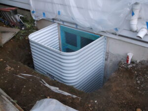 Egress window well bolted to the foundation wall