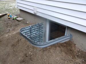 Egress window well showing grading at foundation wall