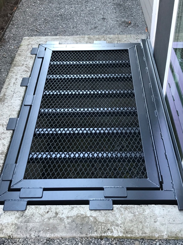 Aluminium Grate with black powder coating and escape hatch.