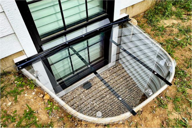 Sloped polycarbonate window well cover with Polylocks