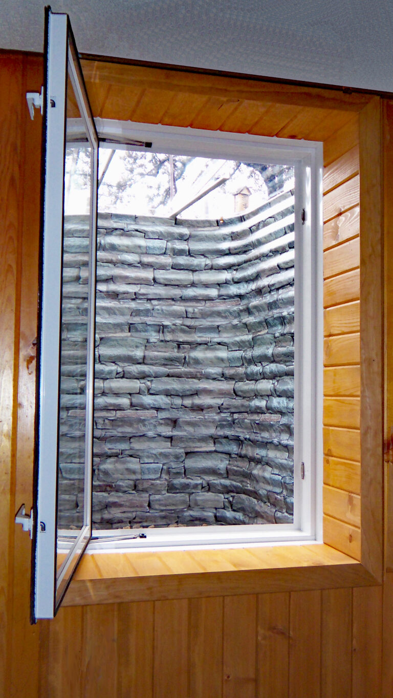 Inward opening basement window with stone egress kit